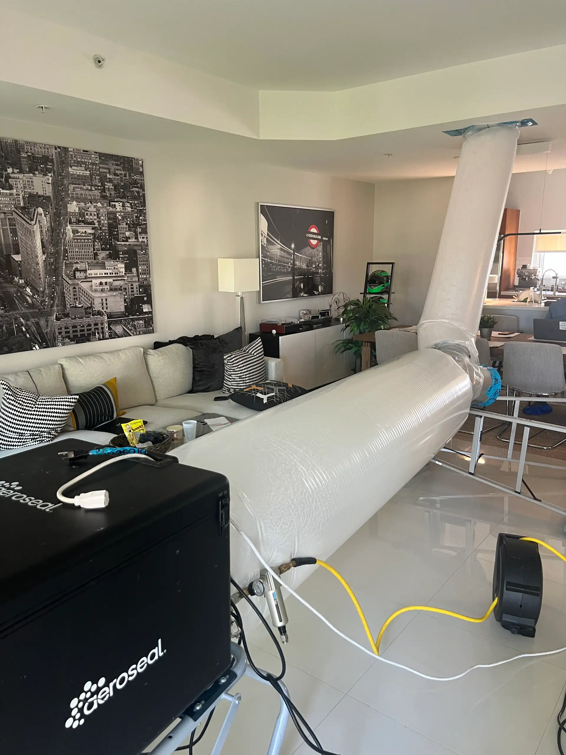 Aeroseal duct sealing service being performed in South Florida residential living room